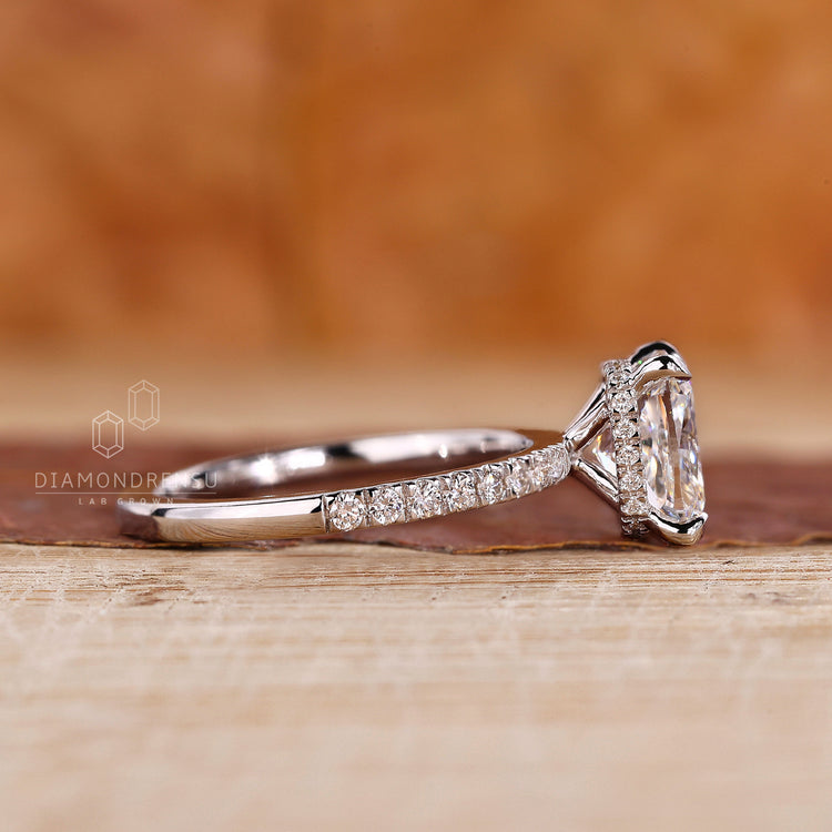 Hidden halo engagement ring with pave setting detail.
