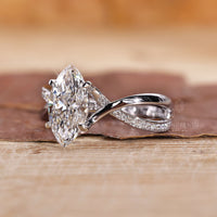 4 claw prong setting ring with marquise diamond and pavé band.
