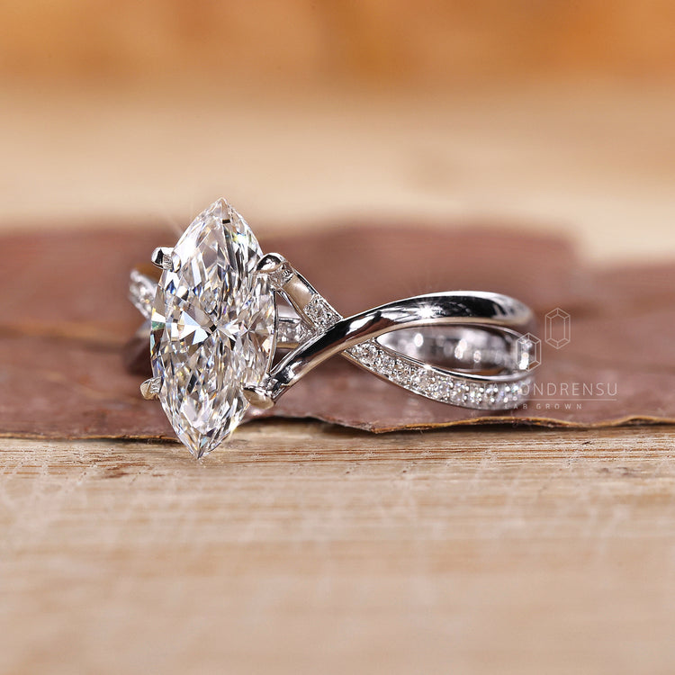 4 claw prong setting ring with marquise diamond and pavé band.
