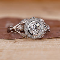 White gold ring featuring bezel set lab grown diamond.
