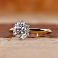 Tab prong setting ring with a custom diamond in yellow gold.
