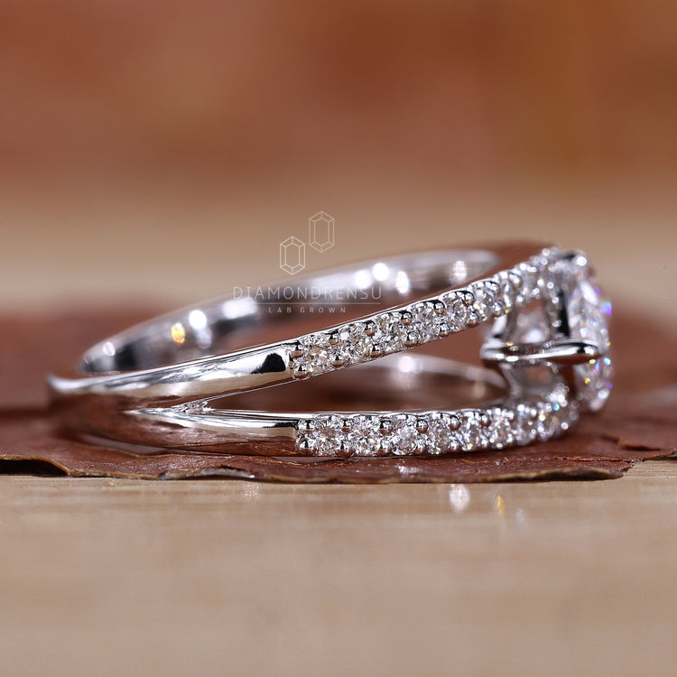 Handmade east west engagement ring with split pave shank band.
