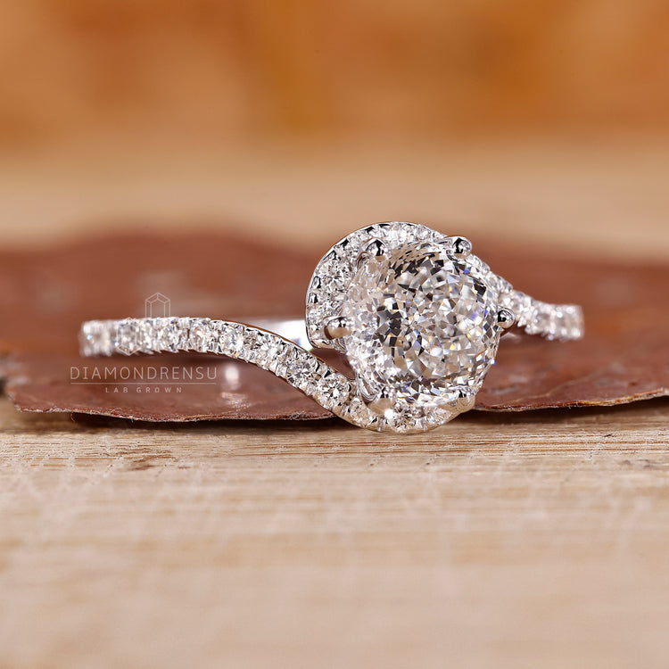 Bypass halo engagement ring set in prong setting.
