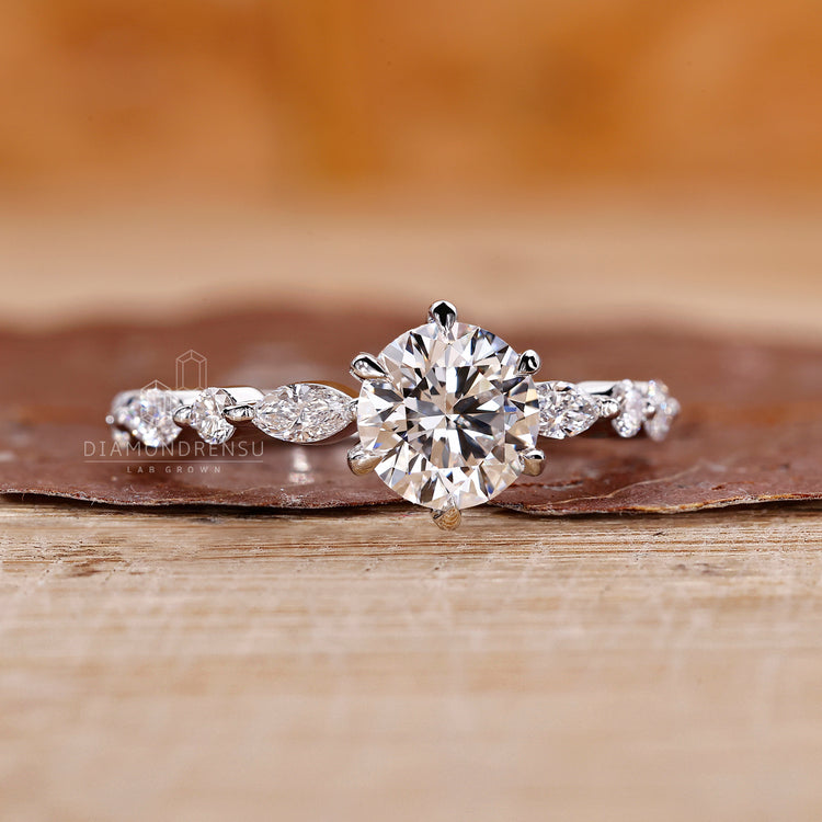 6 claw prong ring holding a brilliant lab grown diamond on a sleek band.
