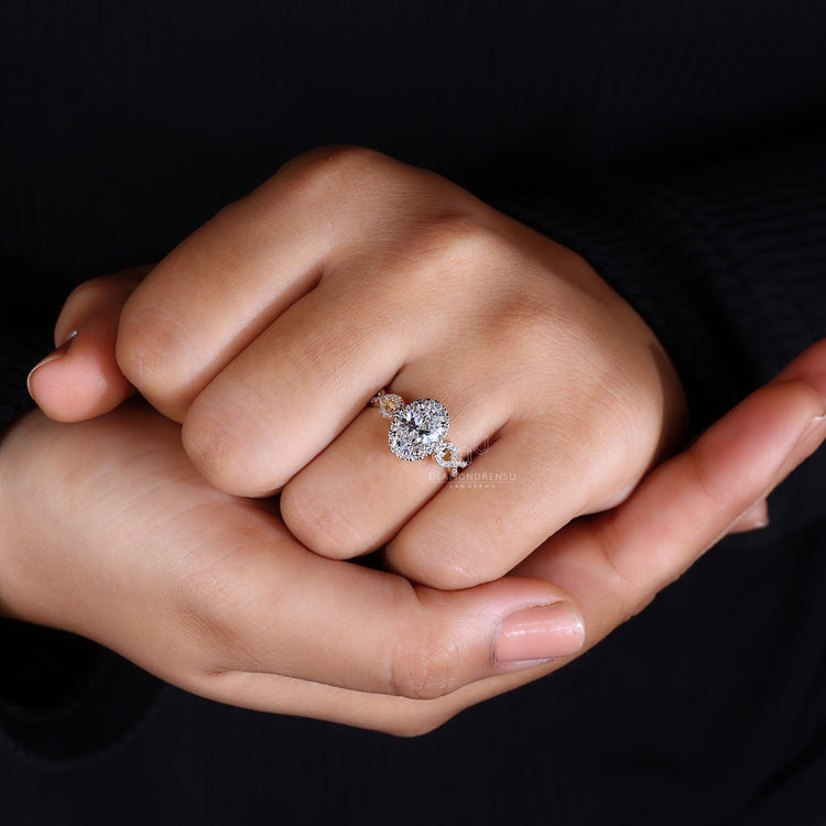 Halo diamond ring featuring oval cut centre and handmade setting.
