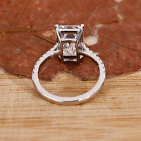 white gold ring in gold emerald cut engagement style.
