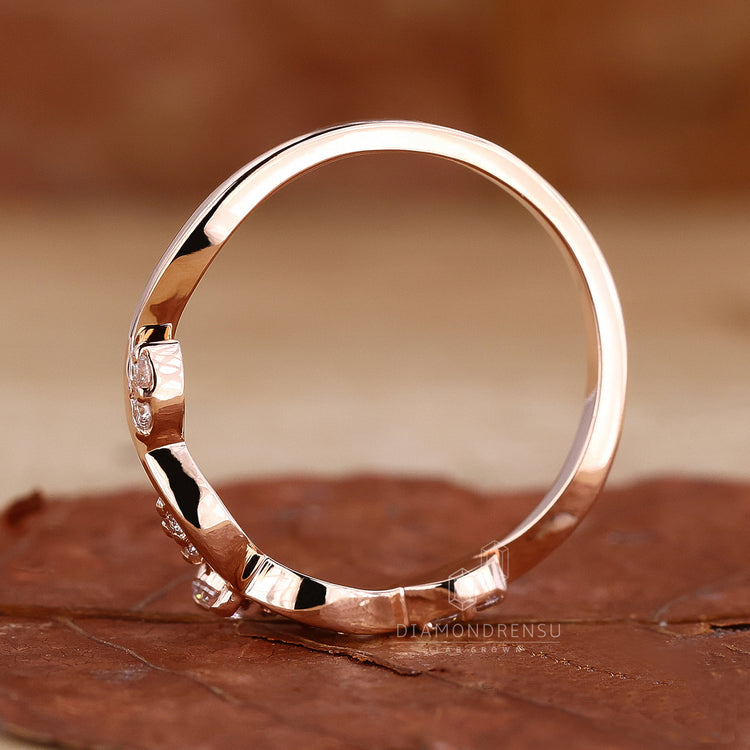 Round cut wedding band with rose gold band.