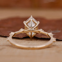 hexagon step cut engagement ring in distance pave style.
