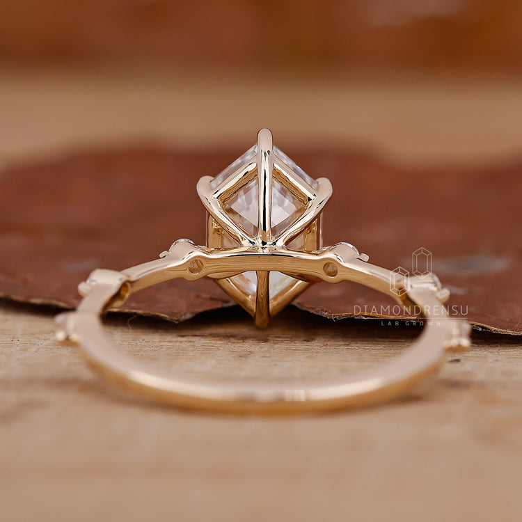 hexagon step cut engagement ring in distance pave style.
