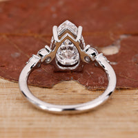 Custom diamond ring designed with pear and round stones in prong setting.

