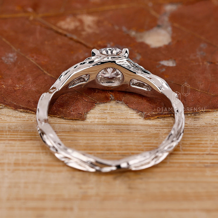 Solitaire setting ring with round diamond and claw prongs.
