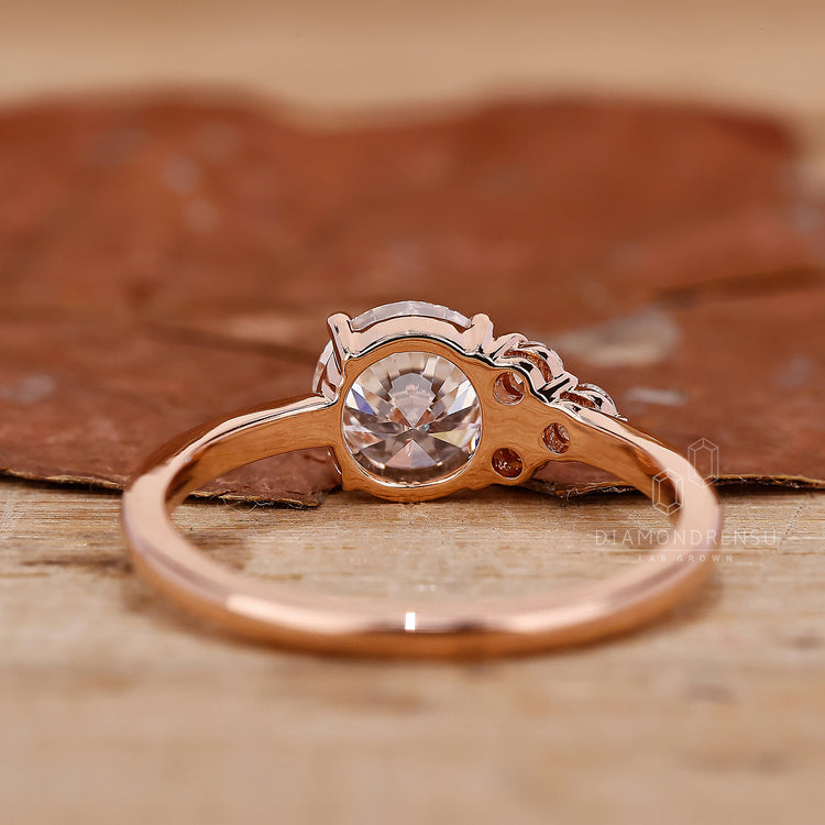 unique engagement ring with round cut side stone.
