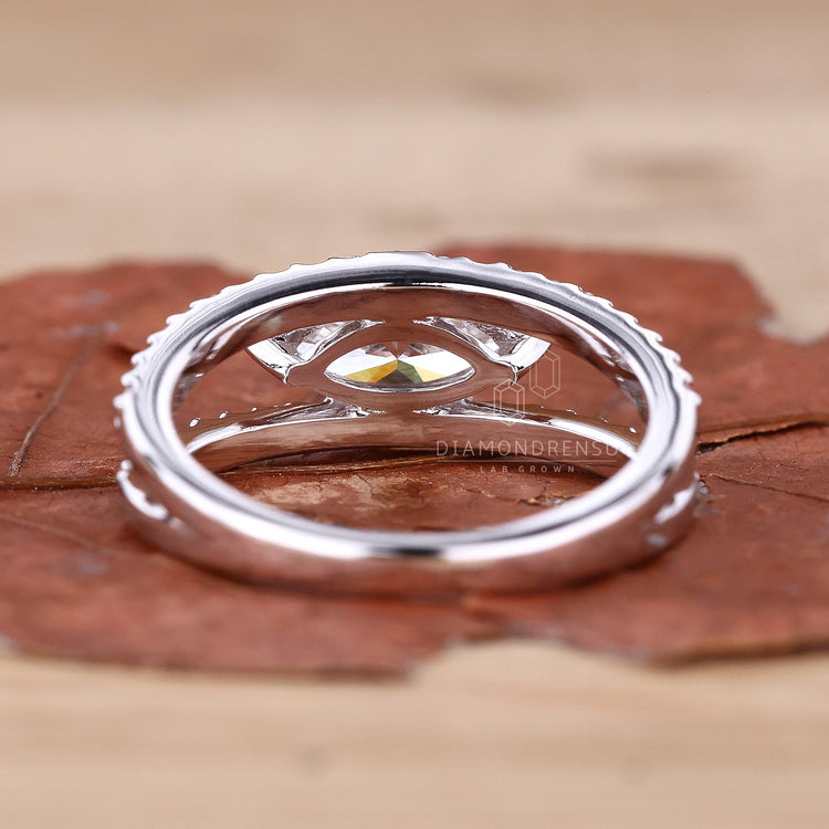 White gold marquise ring with round diamond side stones.
