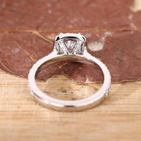 Yellow gold ring with cushion cut lab grown diamond and pavé halo.
