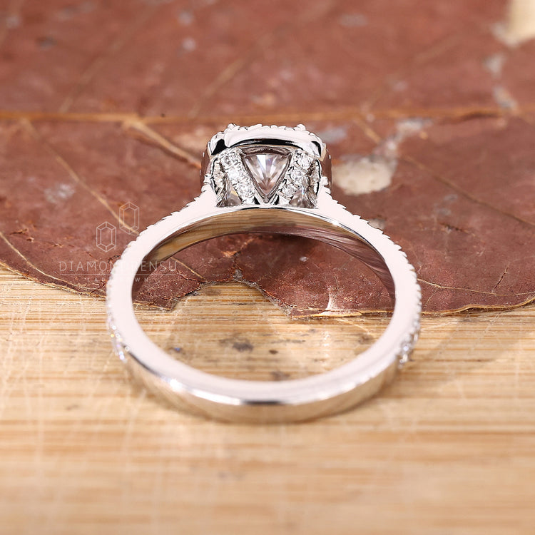 Yellow gold ring with cushion cut lab grown diamond and pavé halo.
