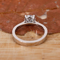white gold engagement ring with round cut side stones.
