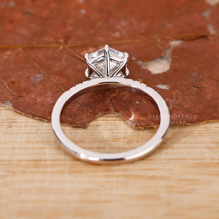 Buy Engagement ring featuring round cut side stones.
