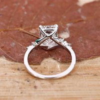 Custom diamond ring with emerald cut centre and muse setting.

