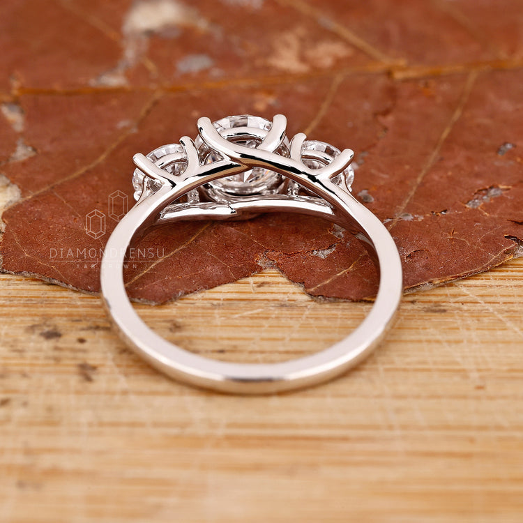 Custom diamond ring with round stones in a trellis setting.
