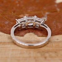 Engagement ring featuring a princess cut and elegant prong setting.
