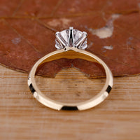 But engagement ring with tab prong setting and round cut diamond.

