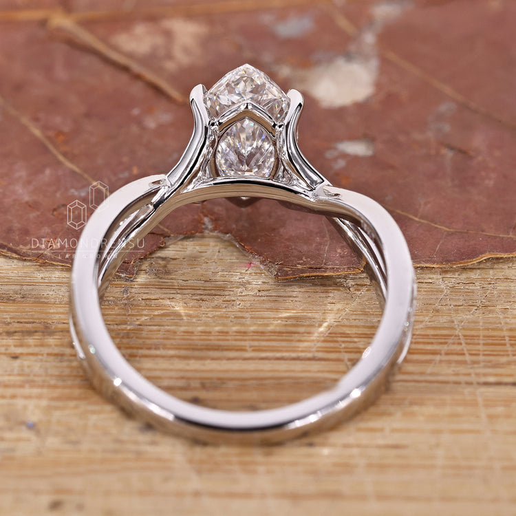 Custom diamond ring with marquise cut and pavé round diamonds.
