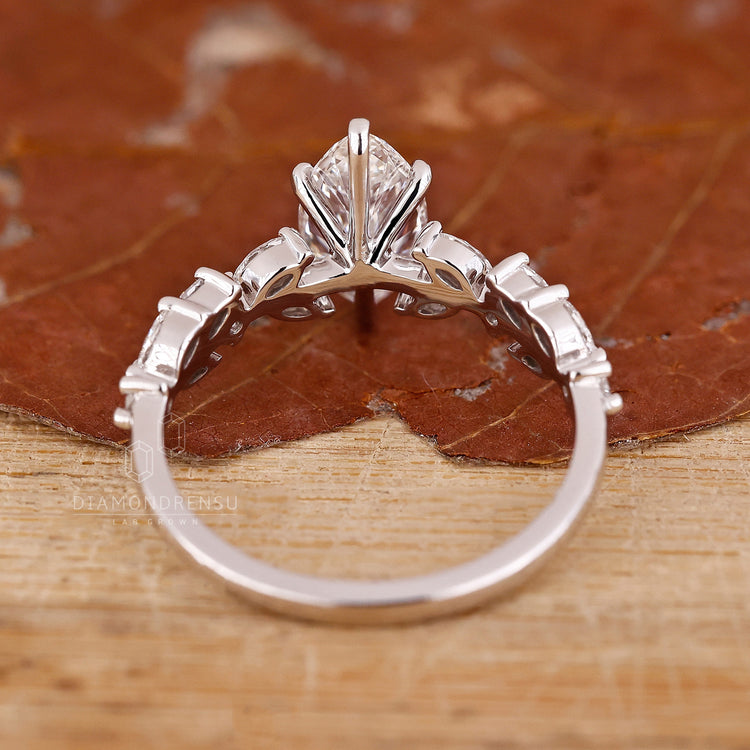 Buy engagement ring with marquise cut diamond and round accents.

