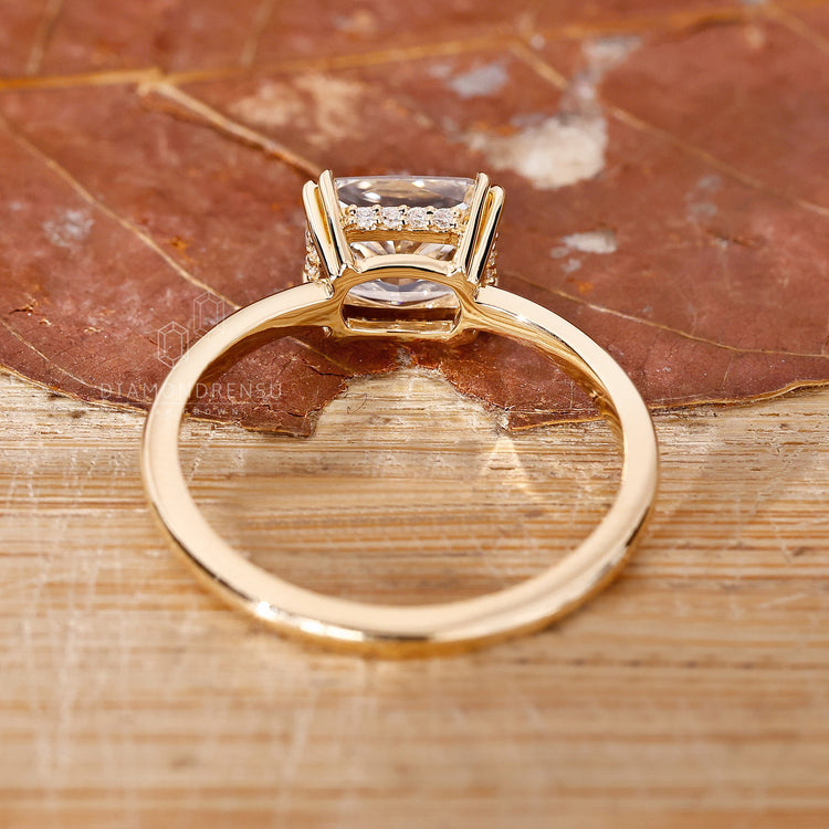 Yellow gold ring with elongated cushion cut and hidden halo.

