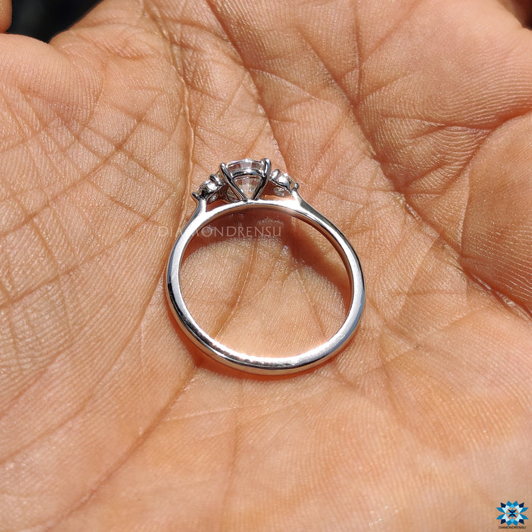 Handmade moissanite three stone engagement ring.