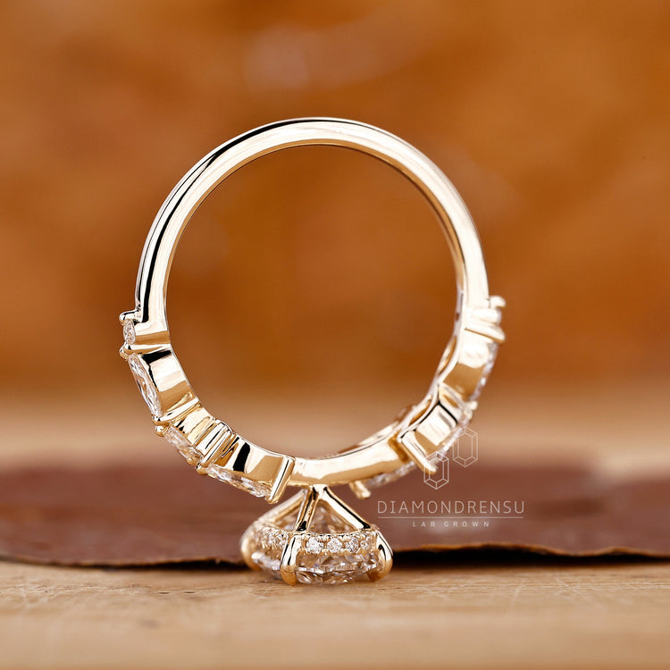 Buy engagement ring with oval centre and marquise side stones.
