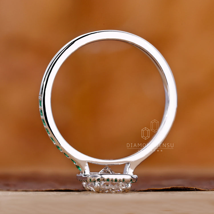 Lab grown diamond radiant cut ring with emerald pave handcrafted in white gold.
