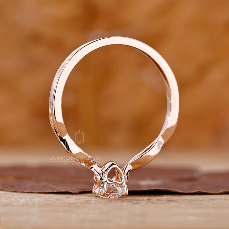 Lab grown diamond solitaire ring with twisted shank and heart prongs.
