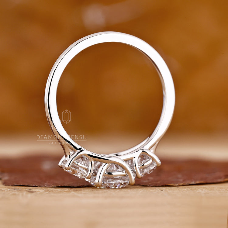 Lab grown diamond ring in a three stone trellis setting.
