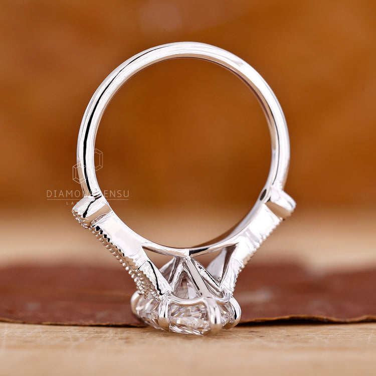Buy engagement ring with vintage design and round side stones.

