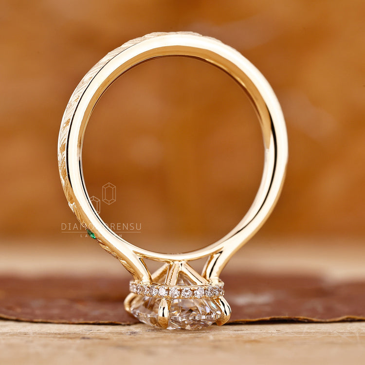 Hidden halo oval engagement ring with a handmade yellow gold band.
