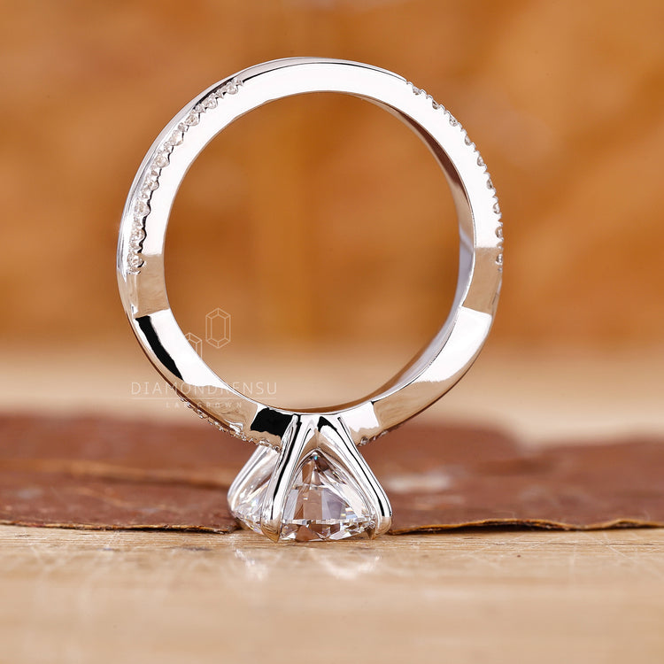 Lab grown diamond engagement ring with a pave setting and 4 claw prongs.
