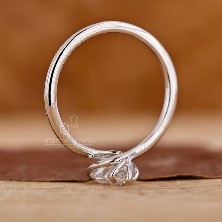 Lab grown diamond twisted engagement ring with solitaire setting in white gold.
