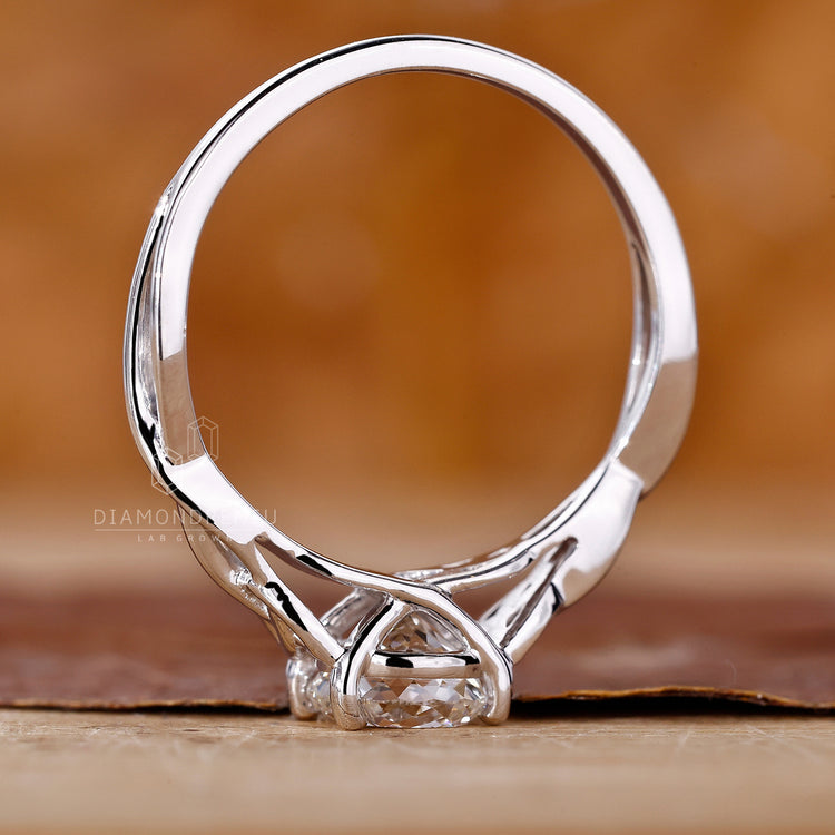 Lab grown diamond solitaire ring with twist shank and prong setting in white gold.
