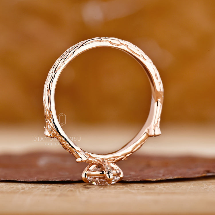 Lab grown diamond engagement ring with round cut stones in rose gold.
