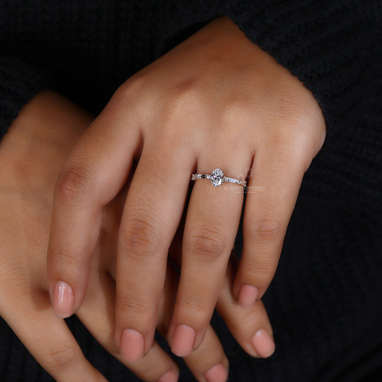 Pavé and baguette diamond side stone engagement ring.
