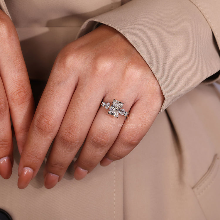 Oval and round side stone in yellow gold engagement ring.
