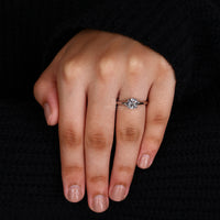 White gold diamond ring featuring a 4 prong center setting.
