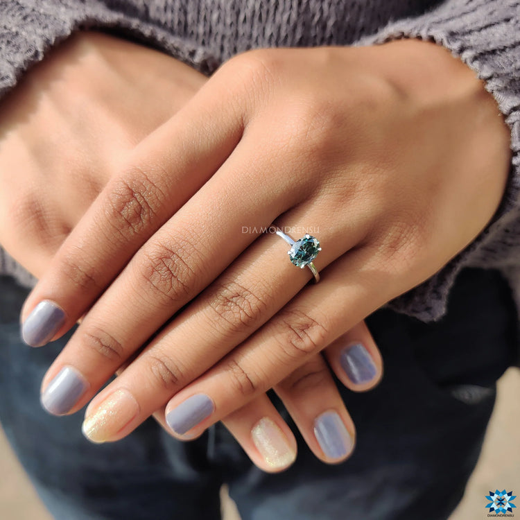 Handmade ring featuring a claw prong setting and oval cut engagement stone.
