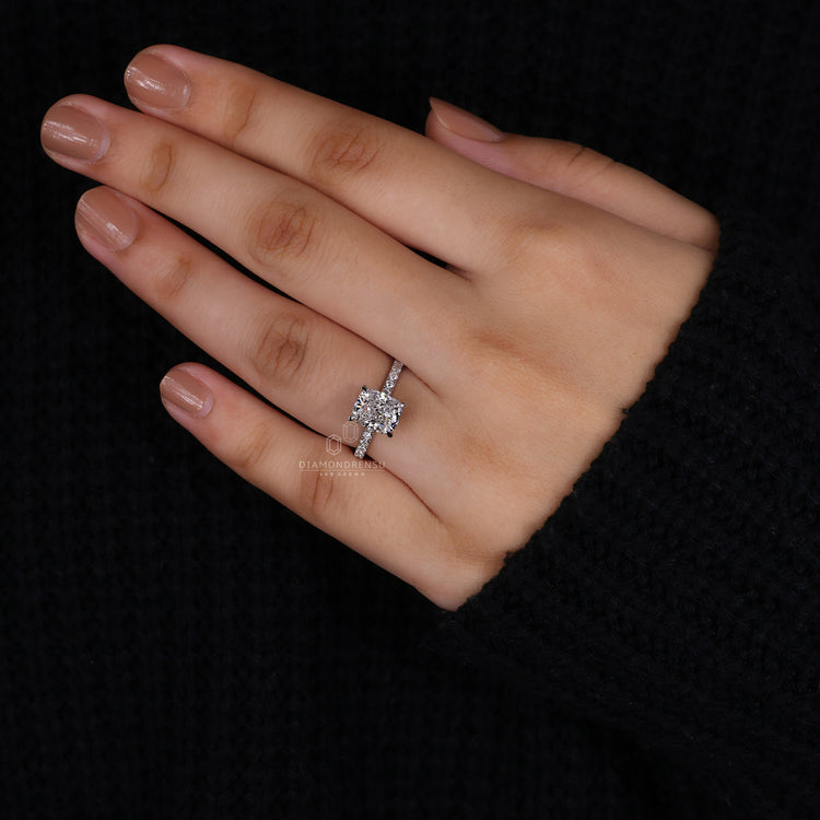 Round cut pave band in a cushion cut diamond ring.
