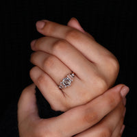 unique engagement ring with round diamond side stone.
