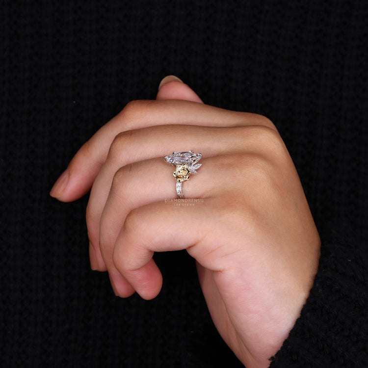 Round side stone ring with Dutch marquise diamond in two tone gold.
