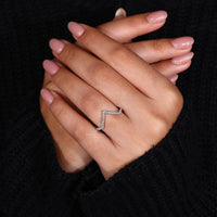 White gold chevron band with diamonds.
