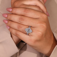 Halo diamond ring with marquise centre and round diamond accents.

