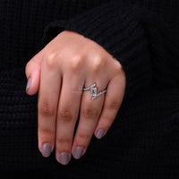 White gold ring with round pave diamonds and bypass setting style.
