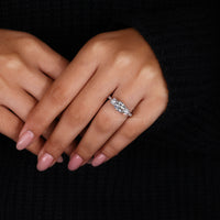 Tapered pave engagement ring with round prong setting.
